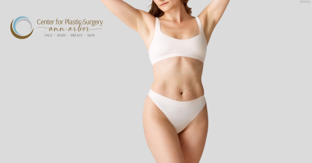 Woman showing body contouring results after liposuction surgery (model)