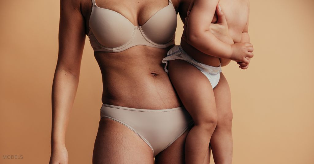 Mother in underwear with her baby. (MODELS)